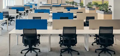 Modern open-plan office space featuring clean workstations, ergonomic chairs, and sanitized carpets provided by professional office cleaning services in Ogden, UT.