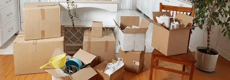 Packed moving boxes and household items in a kitchen before move-out or move-in cleaning, Ogden, UT.